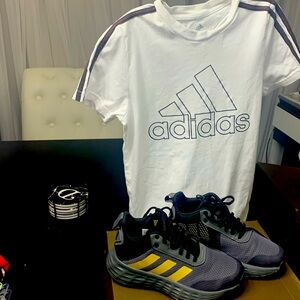 Boys Grey and gold Adidas. The shirt is a size small a little extra